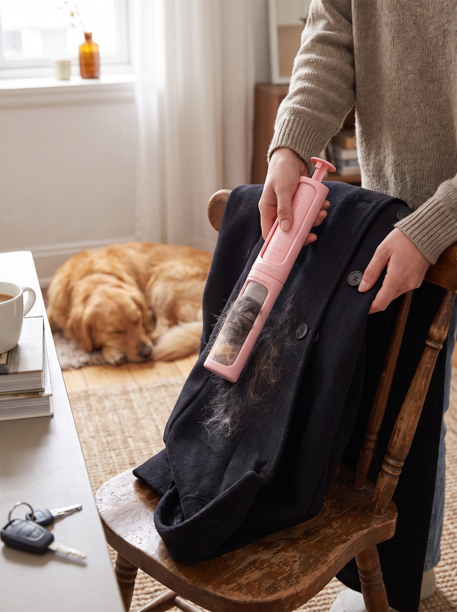Travel lint brush sweeping a dark coat